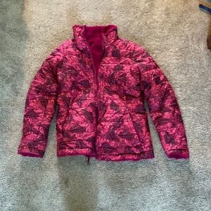 A north face kids coat that is reversible with a fuzzy side and a butterfly side